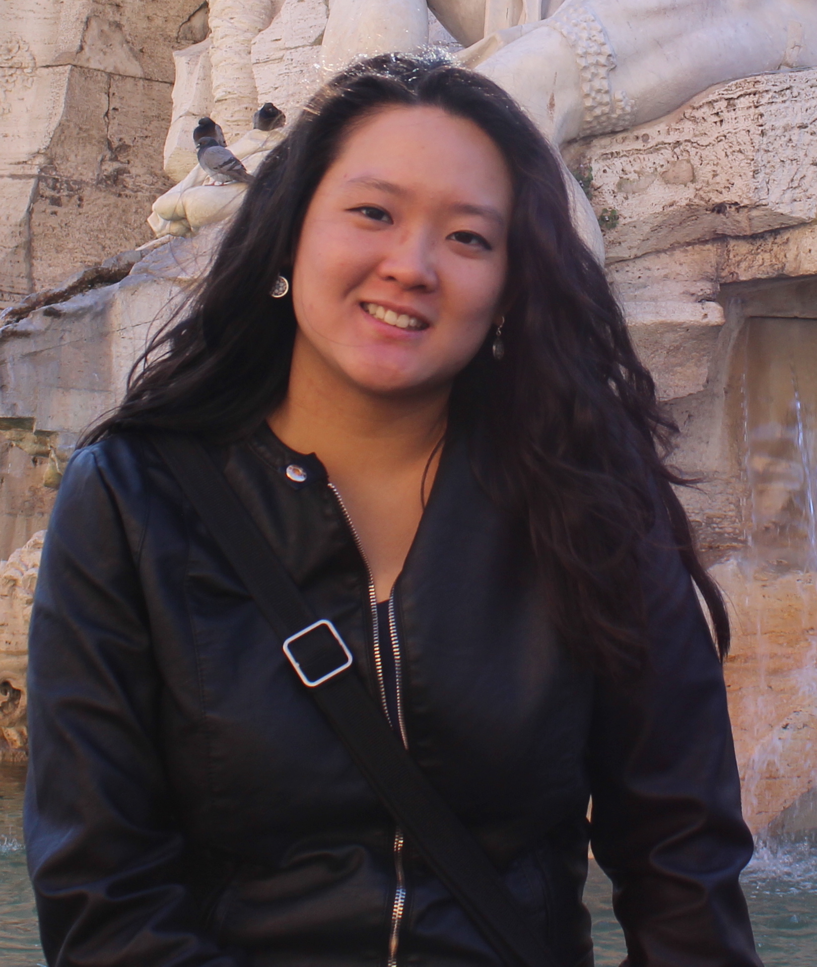 Woman with dark long hair smiling at camera